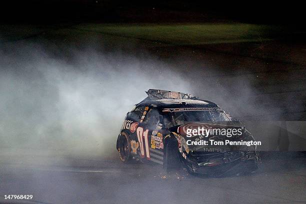 Mike Wallace sits in the wrecked G&K Services Chevrolet, after an incident in the NASCAR Nationwide Series Subway Jalapeno 250 Powered by Coca-Cola...