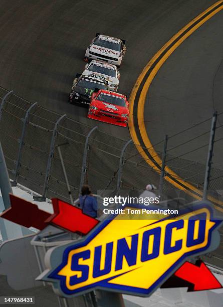 Kurt Busch, driver of the HendrickCars.com Chevrolet, leads Kyle Busch, driver of the Monster Energy Toyota, Danica Patrick, driver of the...