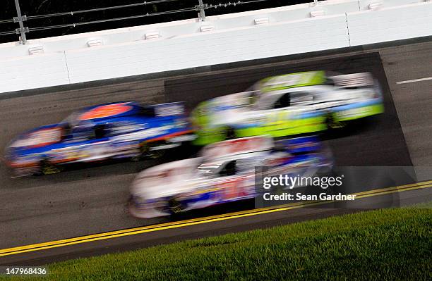 Cars race over new patched pavent in turn three during the NASCAR Nationwide Series Subway Jalapeno 250 Powered by Coca-Cola at Daytona International...