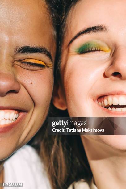 two young beautiful women with bright make-up close-up. diversity concept. - beautiful skin stock pictures, royalty-free photos & images