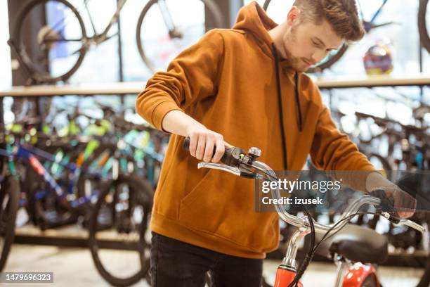 male customer in bicycle shop - sportswear shopping stock pictures, royalty-free photos & images