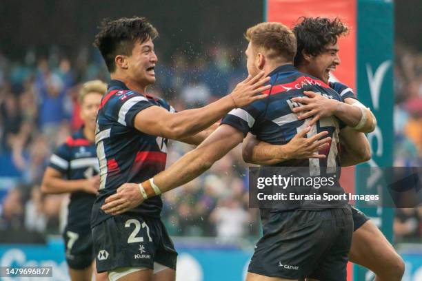 April 2: Liam Herbert of Hong Kong celebrates after scoring a try with James Christie and Russell Webb of Hong Kong during the Hong Kong Sevens at...