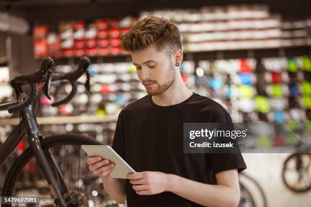 salesman in bicycle shop - sports merchandise stock pictures, royalty-free photos & images