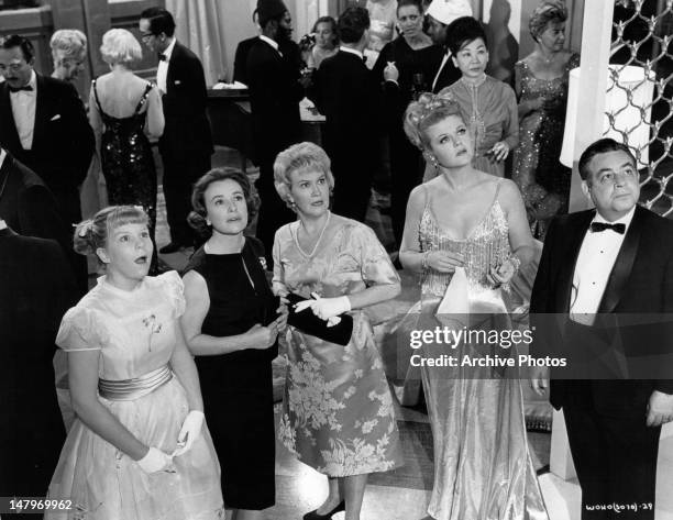 Angela Lansbury and Tom Bosley and others looking up in a scene from the film 'The World Of Henry Orient', 1964.