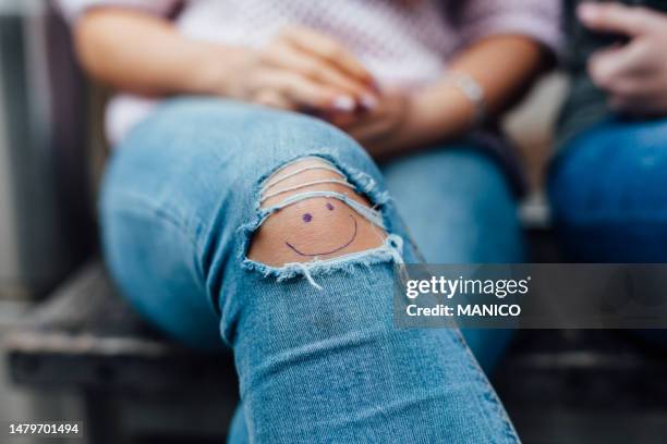 smiley on knee - ripped jeans stock pictures, royalty-free photos & images
