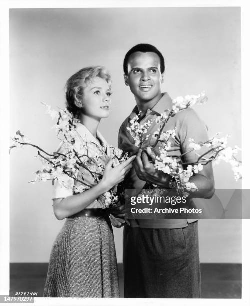 Inger Stevens and Harry Belafonte holding flowers in a scene from the film 'The World, The Flesh And The Devil', 1959.