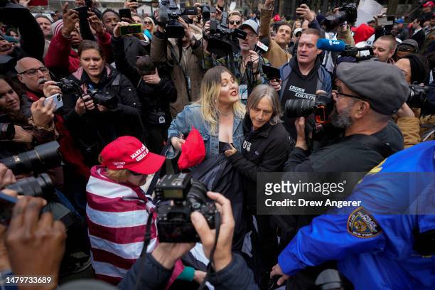 Supporter of former U.S. President Donald Trump scuffles with anti-Trump protesters outside the courthouse where Trump will arrive later in the day...