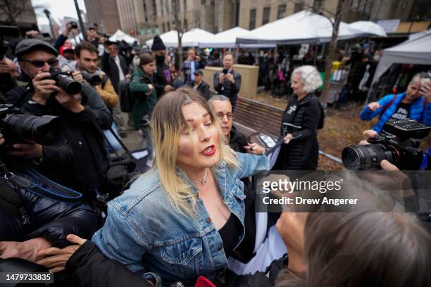 Supporter of former U.S. President Donald Trump scuffles with anti-Trump protesters outside the courthouse where Trump will arrive later in the day...