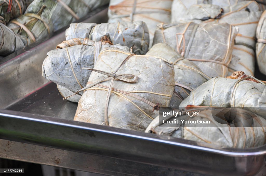 Traditional Chinese food: Delicious Lo Mai Gai (zongzi) dim sum, fresh steamed glutinous rice with chicken roll wrapped by lotus leaf in bamboo steamer in Jiangmen’s restaurant, South China’s Guangdong Province.