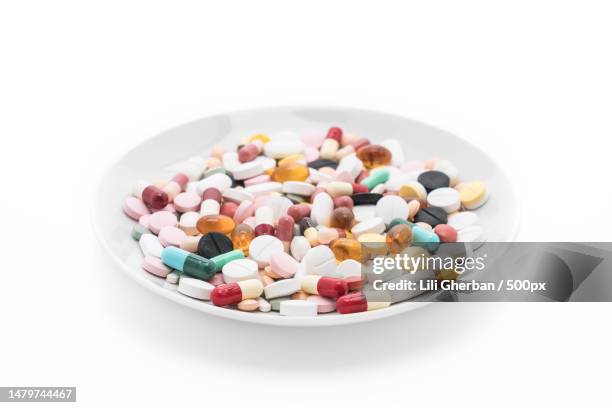 close-up of multi colored candies in plate over white background,romania - loss prevention stock pictures, royalty-free photos & images