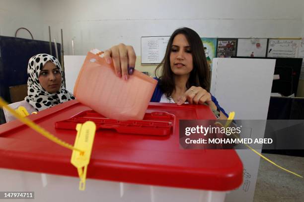 Libyan woman casts her ballot at a polling station in the eastern city of Benghazi during Libya's General National Congress election on July 7, 2012....