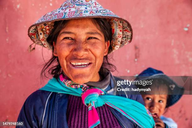 peruvian woman carrying her baby on the back in chivay - peruvian culture stock pictures, royalty-free photos & images