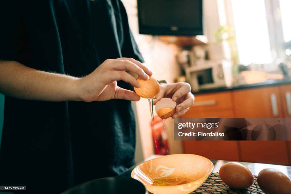 Teenage girl preparing food at home in the kitchen. Cooking food