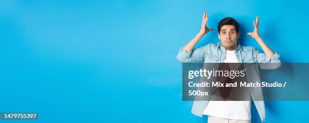 distressed guy showing mind blowing gesture,looking frustrated and - wow stock-fotos und bilder