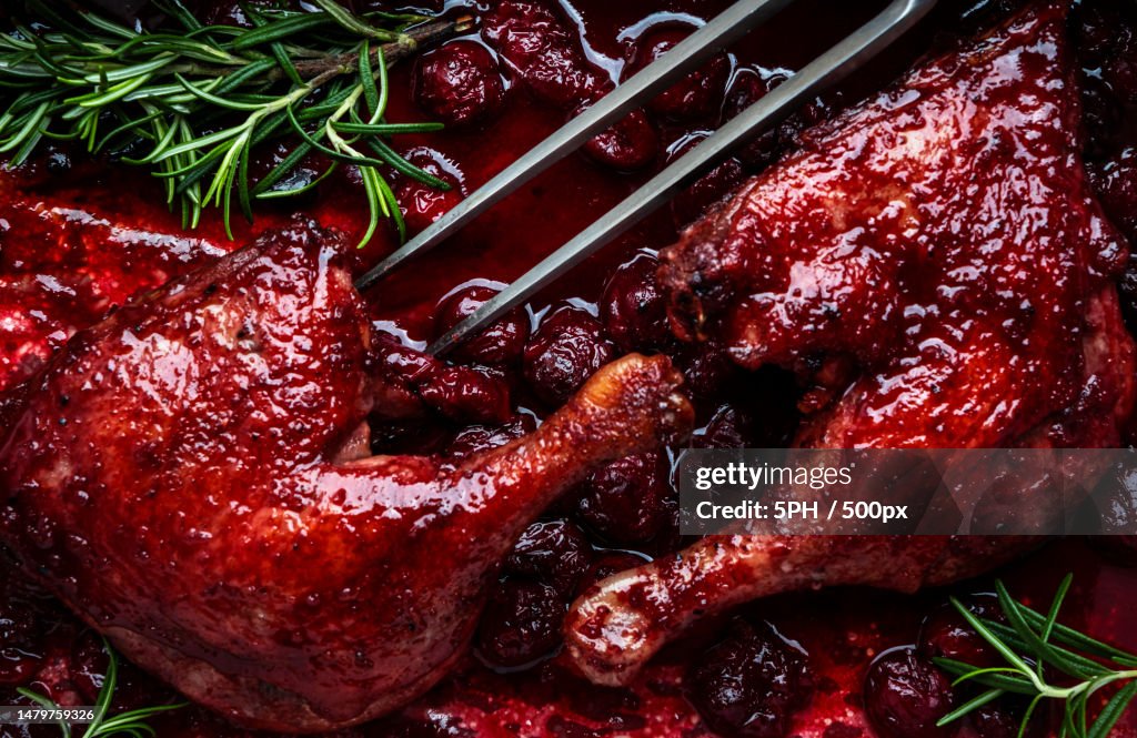 Baked Duck Legs With Cherry Red Wine Sauce With Fresh Rosemary In Old
