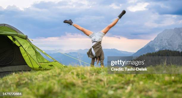 happy woman tourist on the top of the mountain - cartwheel stock pictures, royalty-free photos & images