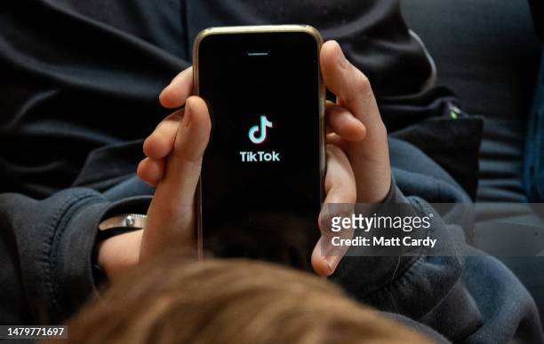 In this photo illustration, a 11-year-old boy looks at the TikTok app on a smartphone screen in the village of St Jean d'Aulps on April 04, 2023 near...