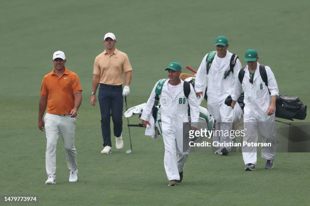 Brooks Koepka of the United States and Rory McIlroy of Northern Ireland walk down the second fairway during a practice round prior to the 2023...