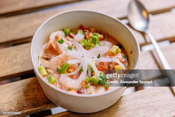 shrimp ceviche with avocado served in a bowl close-up - cultura peruana fotografías e imágenes de stock