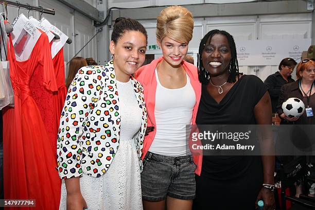 Auma Obama and daughter Akini pose with Luisa Hartema backstage ahead of the Minx By Eva Lux Show at Mercedes-Benz Fashion Week Spring/Summer 2013 on...