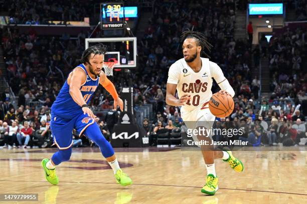Darius Garland of the Cleveland Cavaliers drives to the basket around Jalen Brunson of the New York Knicks during the third quarter at Rocket...