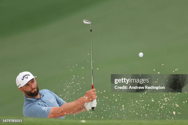 Jon Rahm of Spain plays a shot from a bunker on the tenth hole during a practice round prior to the 2023 Masters Tournament at Augusta National Golf...