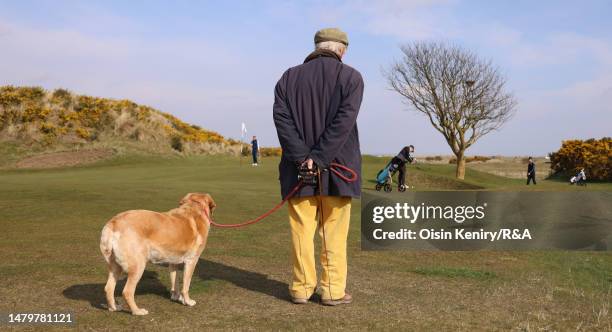 Spectator and his dog watches play on the second hole on Day Two of the R&A Student Tour Series Final at St Andrews Old Course on April 04, 2023 in...