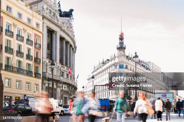 historic building of madrid, the metro station and people passing by - madrid stockfoto's en -beelden