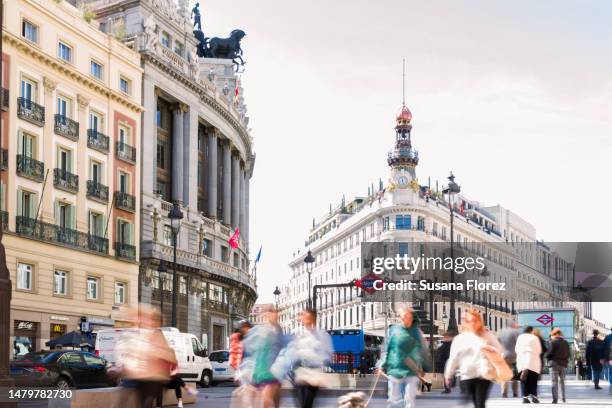 historic building of madrid, the metro station and people passing by - madrid stock pictures, royalty-free photos & images