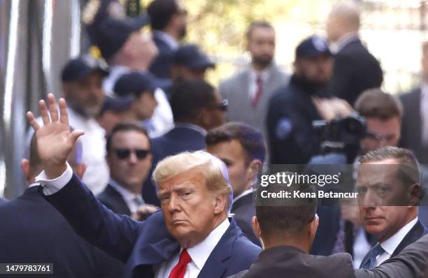 Former U.S. President Donald Trump waves as he arrives at the Manhattan Criminal Court on April 04, 2023 in New York, New York. Trump will be...