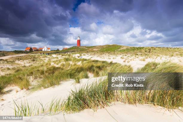 texel lighthouse near village de cocksdorp on a stormy summer day - marram grass stock pictures, royalty-free photos & images