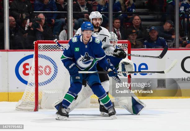 Jack Rathbone of the Vancouver Canucks and Phillip Danault of the Los Angeles Kings screen Thatcher Demko of the Vancouver Canucks during their NHL...