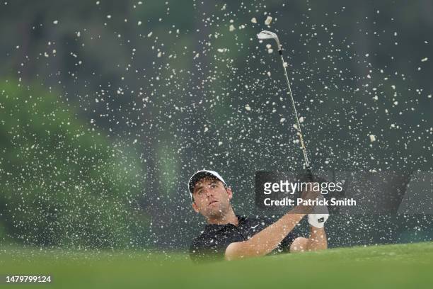 Scottie Scheffler of the United States plays a shot from a bunker on the 17th hole during a practice round prior to the 2023 Masters Tournament at...