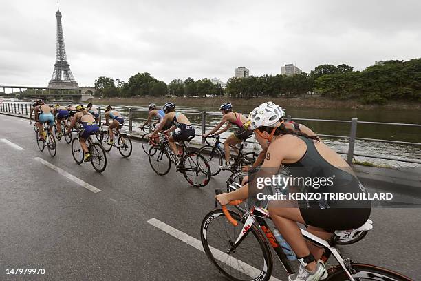 Athletes compete during the 6th edition of the Paris triathlon on July 7, 2012 in Paris. The participants swam a distance of 0.5 miles , ride 12.42...