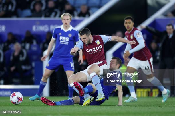 John McGinn of Aston Villa is tackled by Jamie Vardy of Leicester City during the Premier League match between Leicester City and Aston Villa at The...