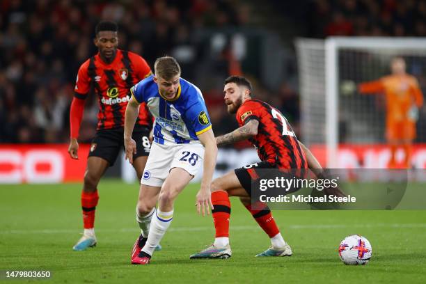 Evan Ferguson of Brighton & Hove Albion is challenged by Marcos Senesi of AFC Bournemouth during the Premier League match between AFC Bournemouth and...