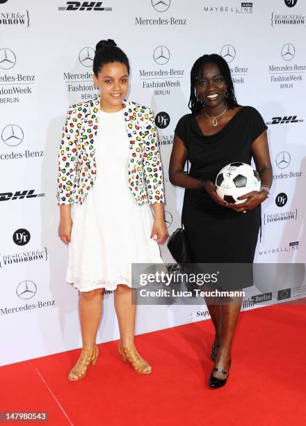 Auma Obama and daughter Akini arrive for the Minx By Eva Lux Show at Mercedes-Benz Fashion Week Spring/Summer 2013 on July 7, 2012 in Berlin, Germany.