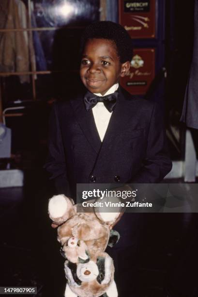 Gary Coleman holds a teddy bear at a red carpet event, United States, 16th September 1984.