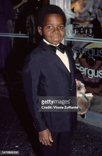 Gary Coleman holds a teddy bear at a red carpet event, United States, 16th September 1984.