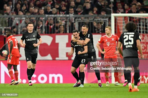 Nicolas Hoefler of Sport-Club Freiburg celebrates with teammate Maximilian Eggestein after scoring the team's first goal during the DFB Cup...