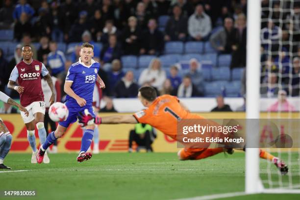 Harvey Barnes of Leicester City scores the team's first goal past Emiliano Martinez of Aston Villa during the Premier League match between Leicester...