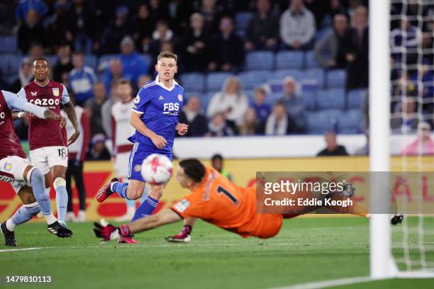 Harvey Barnes of Leicester City scores the team's first goal past Emiliano Martinez of Aston Villa during the Premier League match between Leicester...