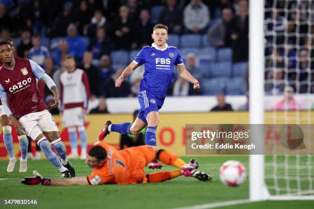 Harvey Barnes of Leicester City scores the team's first goal past Emiliano Martinez of Aston Villa during the Premier League match between Leicester...