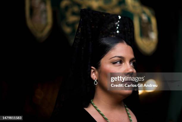 Woman dressed in a "Mantilla" from the "Esperanza" brotherhood looks on during the procession on Holy Tuesday on April 04, 2023 in Granada, Spain. In...