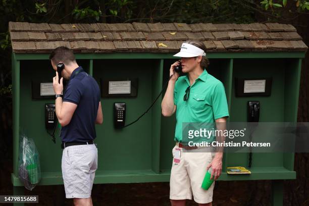 Patrons use a courtesy phone during a practice round prior to the 2023 Masters Tournament at Augusta National Golf Club on April 04, 2023 in Augusta,...
