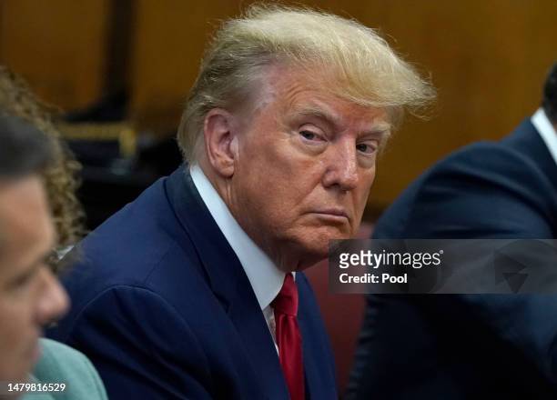Former U.S. President Donald Trump sits with his attorneys inside the courtroom during his arraignment at the Manhattan Criminal Court April 4, 2023...