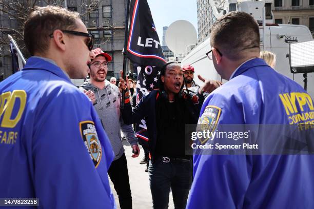 Supporters of former President Donald Trump argue with police outside of the Manhattan Criminal Court during his arraignment on April 04, 2023 in New...