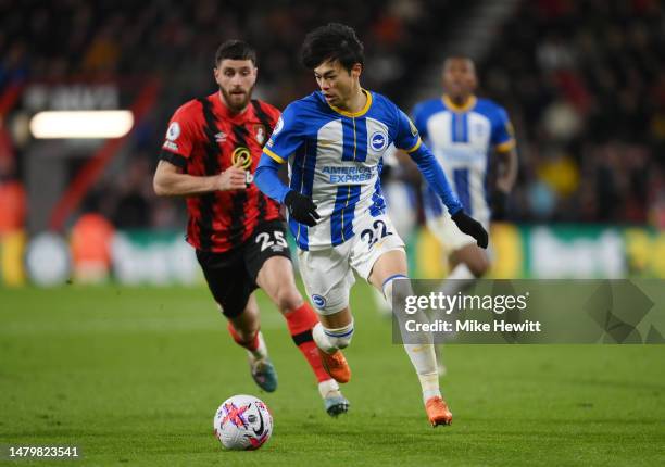 Kaoru Mitoma of Brighton & Hove Albion runs with the ball whilst under pressure from Marcos Senesi of AFC Bournemouth during the Premier League match...