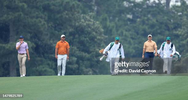 Rory McIlroy of Northern Ireland, Brooks Koepka of the United States and Gordon Sargent of The United States walk to their second shots on the ninth...