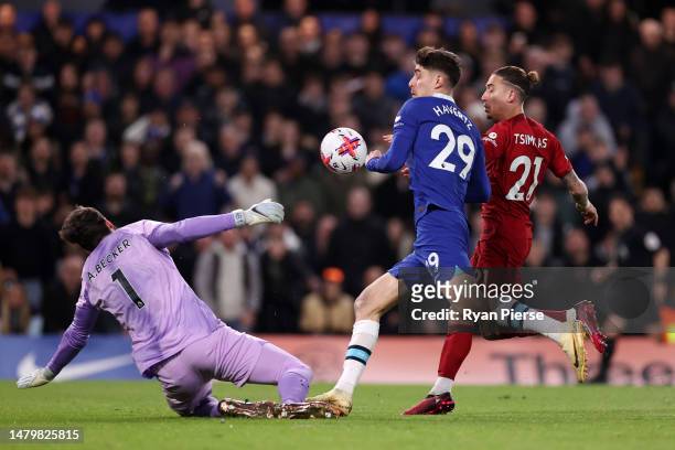 Kai Havertz of Chelsea handballs while under pressure from Alisson Becker of Liverpool and Kostas Tsimikas of Liverpool during the Premier League...